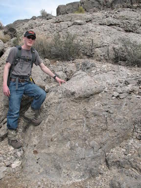 Andrew Retzler, lead author and ISU Master of Science degree geology grad, standing on the rocks deposited inside the Alamo crater.