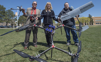 From left, Scott Rasmussen, dean of the ISU College of Technology, Donna Delparte, ISU assistant professor of geosciences, and Shane Slack, Coordinator/Instructor ISU College of Technology Robotics and Communications Systems Engineering Technology with UAS. (Photo by Bethany Baker, ISU Photographic Services)