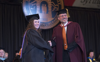 Graduate Rochelle Tharp receives congratulations from ISU Vice President for Research Cornelis Van der Schyf.