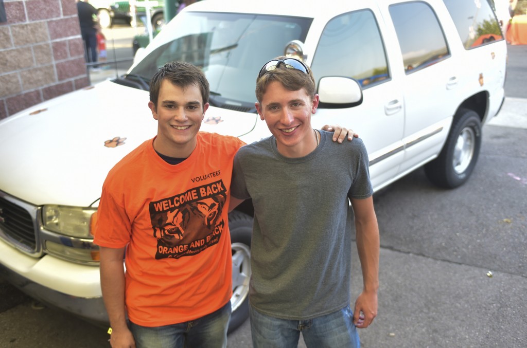  Roommates Vito Kelso, left in orange shirt, and Colton Bankhead won cars at the Welcome Back Orange and Black celebration in consecutive years. The 2015 WBOB car is in the background. 